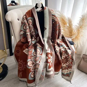 Detail of bohemian mandala patterns and fringe on warm cashmere-like shawl
