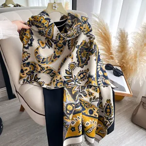 Close-up of ethnic paisley print shawl with decorative tassels and rich embroidery