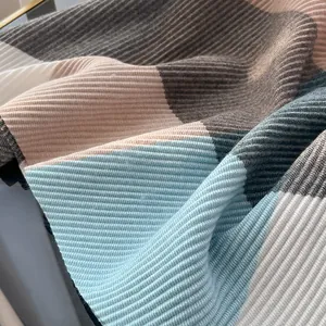 Macro detail of ribbed knit scarf fabric with soft color block stitching and soft texture