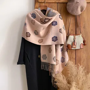 Jacquard scarf with rose floral patterns and tassels worn over a black winter coat
