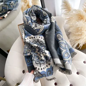 Detailed macro view of vintage paisley pattern on cashmere-like fringed winter scarf