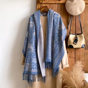 Gedetailleerd overzicht van een blauw beige pashmina sjaal met paisley patroon en franjes
