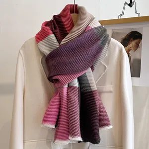 Detail of multi-color pleated scarf with vertical creases and soft knitted texture