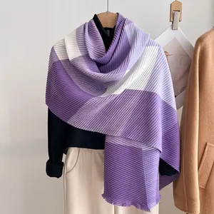 Detail of purple and white gradient pleated scarf showing fine texture and frayed edges