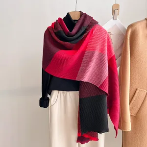 Detail of red and black color-block pleated scarf with accordion fold texture