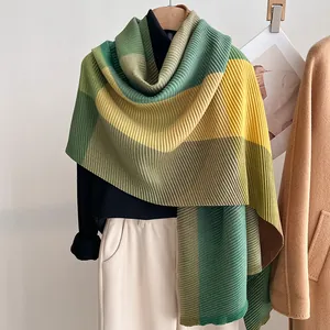 Detailed macro view of pleated scarf texture in green and yellow colorblock design