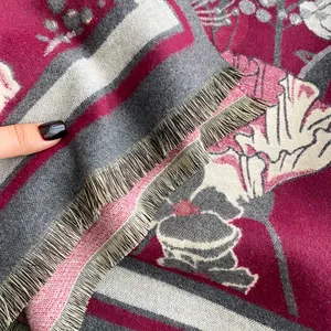 Detailed view of thick floral jacquard scarf with fine fringes and soft texture