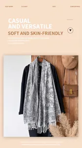 Detail of grey paisley pattern scarf with soft tassels on a black coat setup