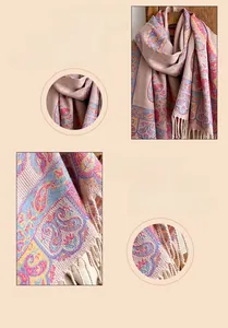 Detailed close-up of pink paisley jacquard pattern and thick tassel fringe on cashmere scarf