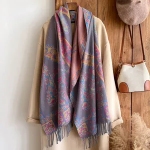Close-up of vintage paisley floral pattern and long fringe on thick cashmere-like scarf