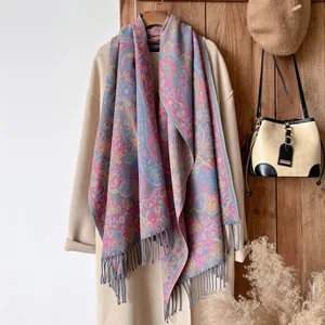 Close-up of paisley jacquard pattern with fringe details on a soft cotton ethnic shawl scarf
