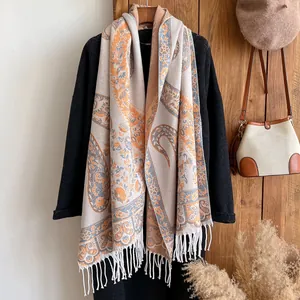 Close-up of paisley pattern pashmina scarf with soft fringe edges and detailed knit texture