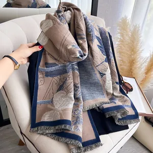 Detailed view of dark blue and brown floral jacquard scarf with fine fringed edges