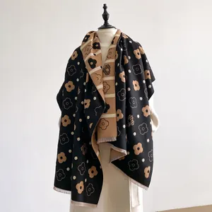 Detailed view of floral pattern and fringe edge on cashmere-feel scarf and shawl