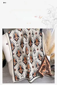 Detail of warm imitation cashmere scarf featuring vintage ethnic patterns and fringe edges