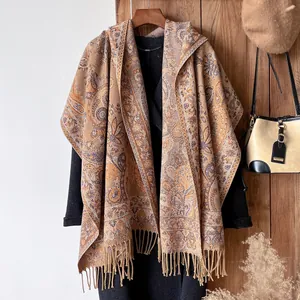 Detailed view of paisley pattern jacquard shawl with decorative fringe tassels