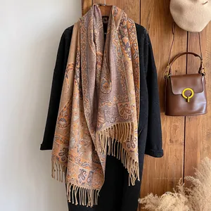 Detail of vintage paisley pattern cashmere-like shawl with neat fringe and thick texture