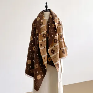 Close-up of double-sided floral pattern on thick cashmere-like scarf with fringe details