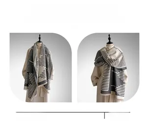 Detailed view of the thick geometric knit shawl worn as both a scarf and a shoulder wrap