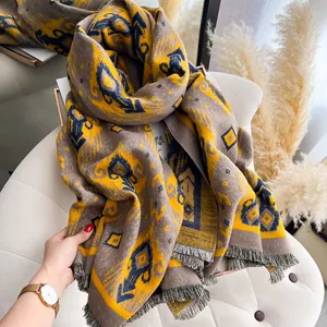 Close-up of thick pashmina scarf with ethnic geometric patterns and delicate tassels