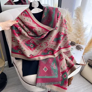 Detail of bohemian geometric pattern and tassels on a thick winter cashmere-like scarf