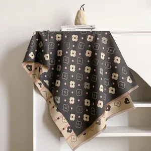 Close-up of floral cashmere feel scarf with tassels hanging on a white cabinet