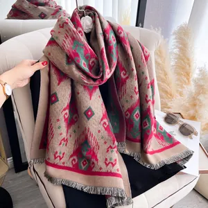 Detailed view of bohemian geometric pattern scarf with fringe on a white sofa