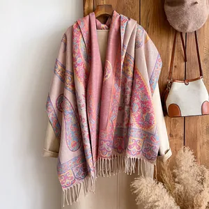 Detail of vintage paisley pattern on thick cashmere-like scarf with fringe edges