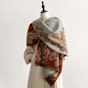 Detail of vintage paisley floral cashmere scarf with elegant fringe and contrasting colors