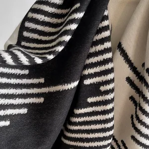 Modern black and white geometric knit shawl scarf with delicate woven texture