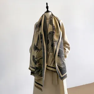 Detail view of tulip printed shawl with soft tassels on beige cashmere-like fabric