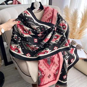Detail shot of vintage geometric totem patterns and soft tassels on the cashmere scarf