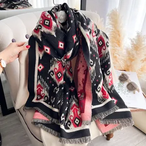 Detail of vintage geometric jacquard pattern and soft tassel edges on pashmina scarf