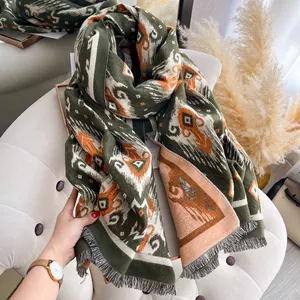 Detail of vintage bohemian geometric patterns and soft fringes on a thick winter shawl