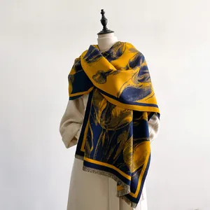 Detail view of floral tulip cashmere scarf with fringe trim draped over a mannequin