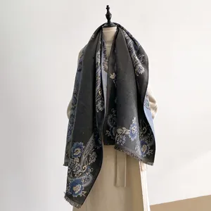 Detail of premium cashmere-like scarf showing vintage paisley patterns and soft fringe tassels