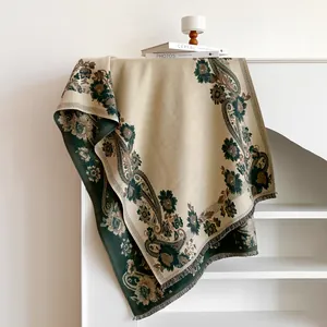 Detailed macro view of vintage paisley jacquard scarf with fine fringe trim and retro patterns