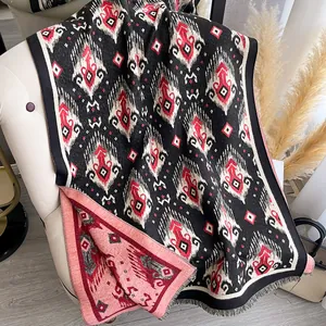 Ethnic ikat pattern cashmere shawl with red geometric prints and fringe details