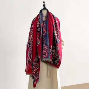 Detail of vintage paisley pattern cashmere-like scarf with warm ethnic floral embroidery