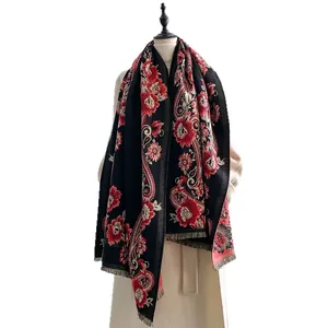 Vintage cashmere-like scarf with red floral patterns and tassels on a white background