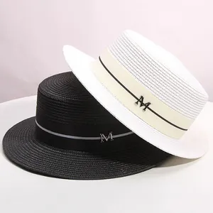 Elegant flat top boater hats in white and black with straw texture and metal M detail