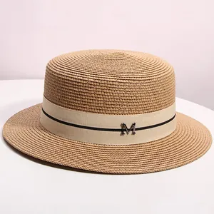 Elegant natural straw boater hat with a chic ribbon and a metallic M letter accent