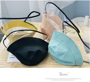Flat lay of cotton kids bucket hats in four colors with clear PVC protective face shields