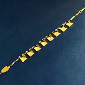 18K gold plated chain bracelet featuring geometric square pyramid charms on blue background