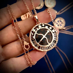 Detailed macro view of Sagittarius coin necklace with rose gold finish and starry engraving