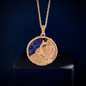 Macro shot of rose gold koi fish relief pendant with blue gemstone inlay detail