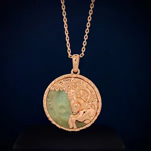 Macro detail of Aries zodiac relief pendant with semi-precious stone in rose gold
