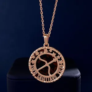 Macro shot of rose gold Sagittarius coin pendant with semi-precious stone inlay