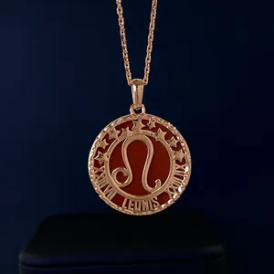 Detail of rose gold Leo zodiac necklace with red enamel coin pendant and Roman numerals