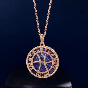 Macro detail of rose gold Pisces zodiac pendant with semi-precious blue stone and roman numerals